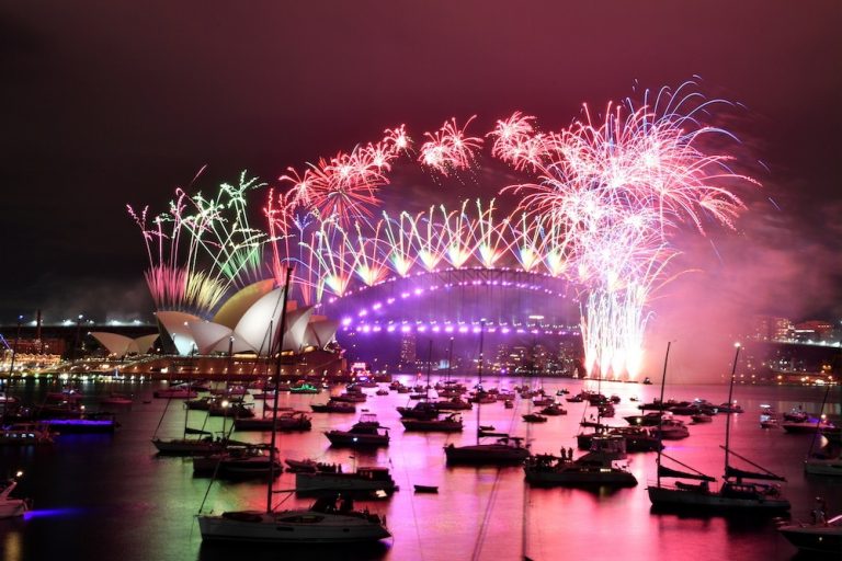 Fireworks explode over empty Sydney streets as 2020 slinks away into history